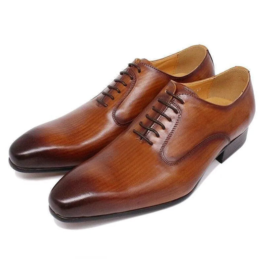Brown leather men's dress shoes with lace-up design on white background