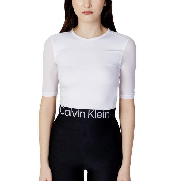 Woman wearing white fitted top and black Calvin Klein branded leggings, fashion apparel