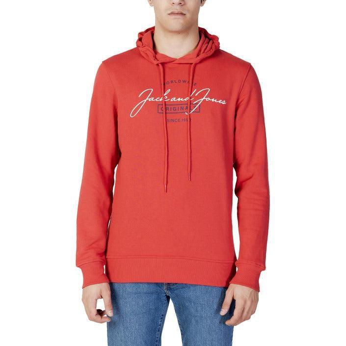 Man wearing red Jack and Jones hoodie with logo and blue jeans, studio background