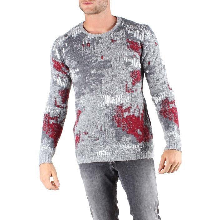 Men's knit sweater with abstract grey and red pattern, paired with grey jeans