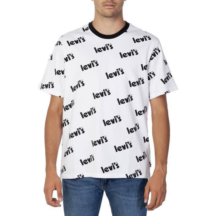 Man in blue jeans wearing a white Levi's logo print t-shirt on a plain background