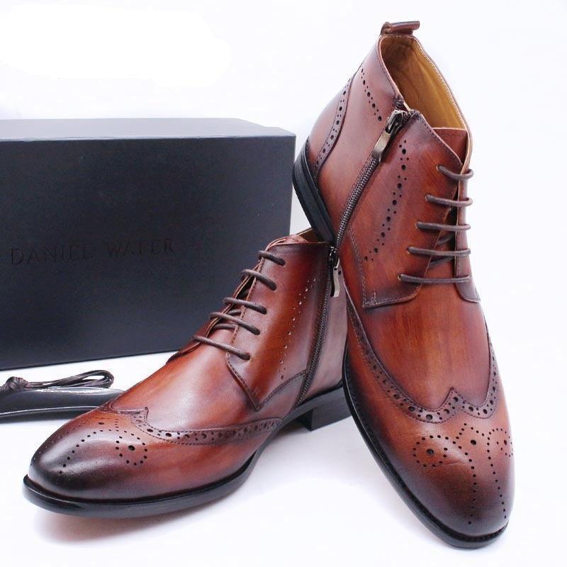 Brown leather men's dress boots with brogue detailing and zippers, displayed on a white background.
