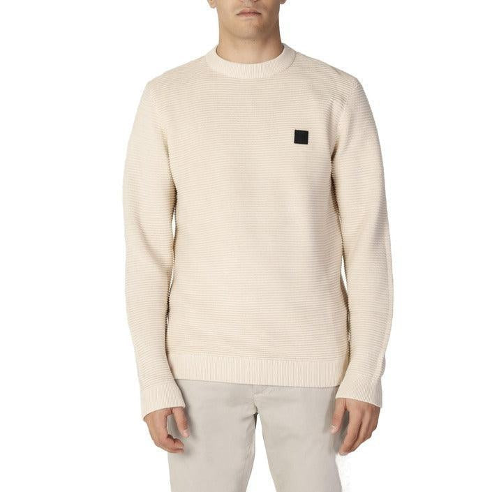 Man wearing cream knit sweater and beige pants, men's clothing collection