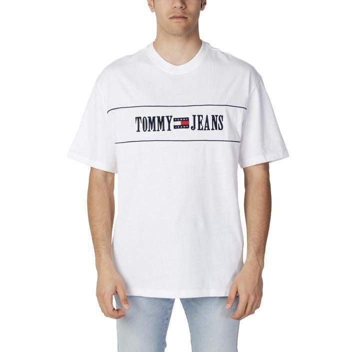 Male model wearing white Tommy Jeans T-shirt and light blue jeans, Tommy Hilfiger collection