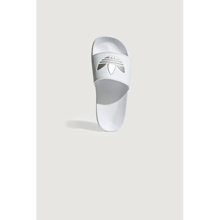 White women's slide slipper with logo on strap, minimalist background