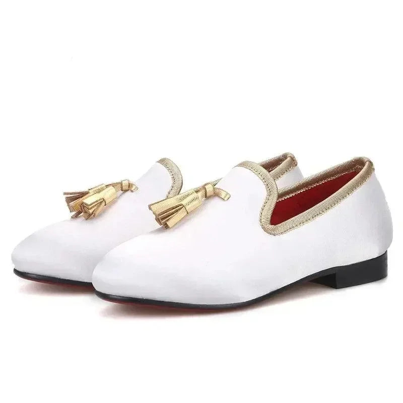 White kids loafers with gold tassels and gold trim fashion image