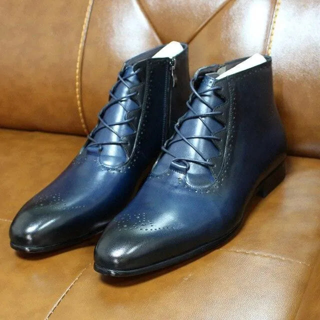 Men's navy blue lace-up formal ankle boots with brogue detail on a brown leather seat