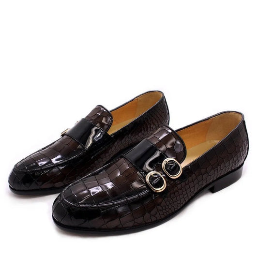 Men's black crocodile pattern dress loafers with gold buckles on a white background
