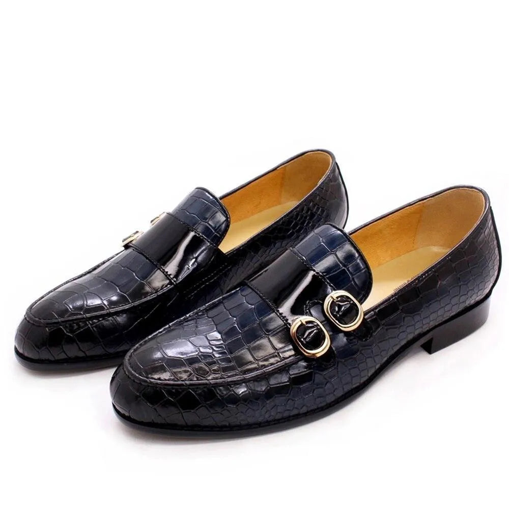 Men's black crocodile pattern dress loafers with gold buckles on white background