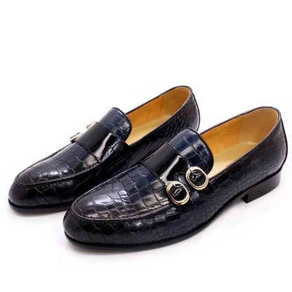 Men's black crocodile pattern dress loafers with gold buckles on white background