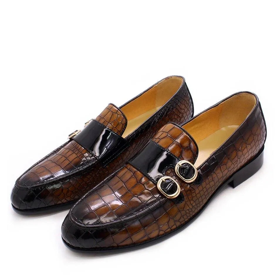 Men's brown crocodile pattern dress loafers with double gold buckles on white background.