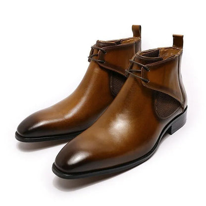 Brown leather ankle dress boots with laces, black soles, and sleek design on white background.