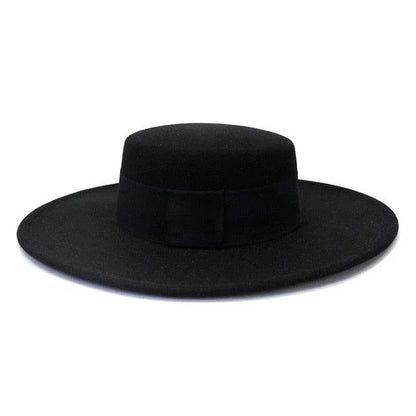Black derby fedora hat with wide flat brim on white background