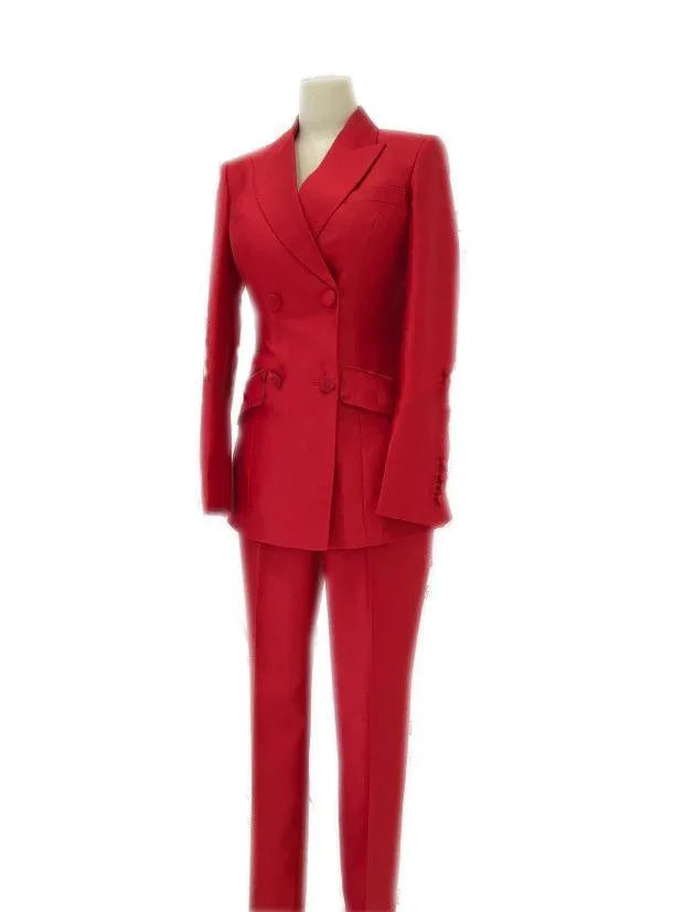 Red double-breasted women's business pantsuit with tailored blazer and trousers on mannequin