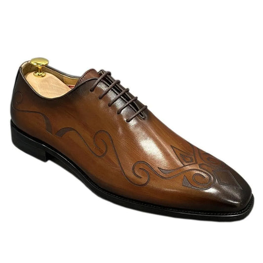 Brown leather men's dress shoe with unique swirl pattern and black sole on white background