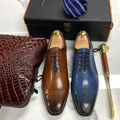 Brown and blue classic leather men’s dress shoes with embossed pattern, tie, and briefcase
