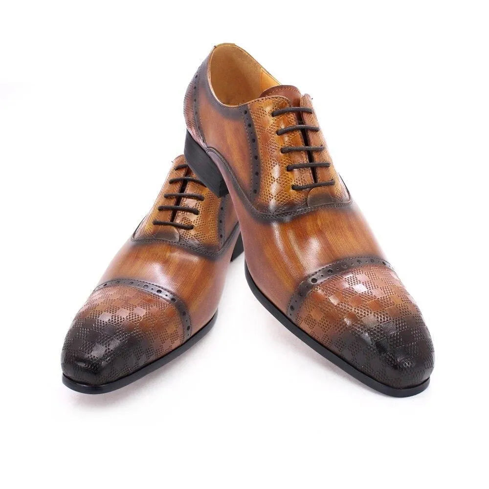 Brown leather lace-up men's dress shoes with brogue and textured cap toe detail on white background