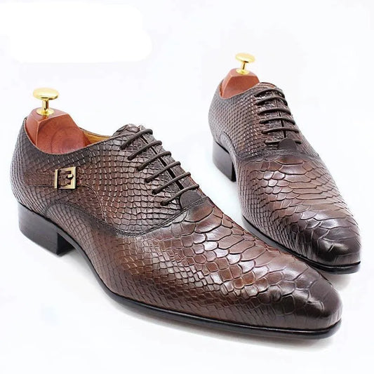 Brown men's dress shoes with lizard skin pattern on white background