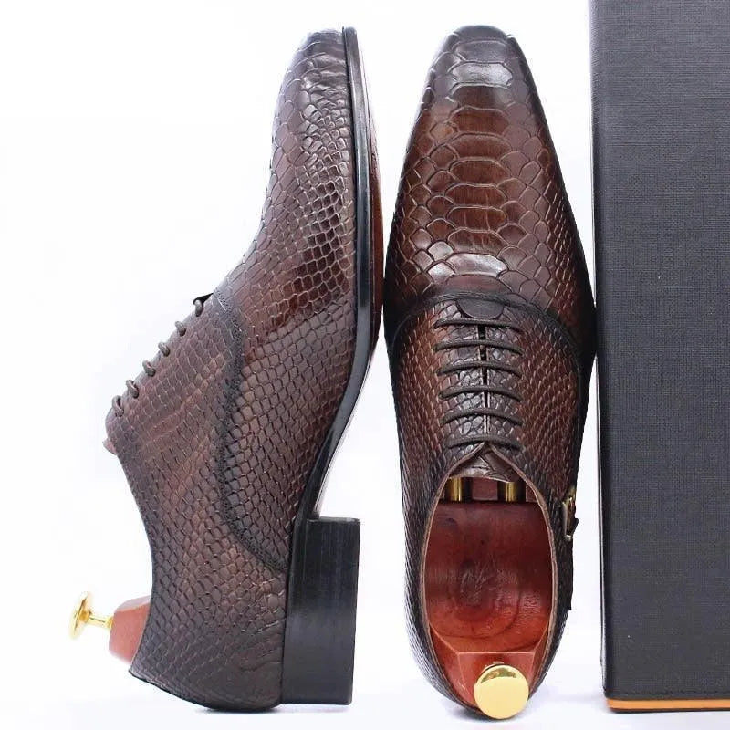 Brown leather dress shoes for men with snakeskin pattern and wooden shoe trees