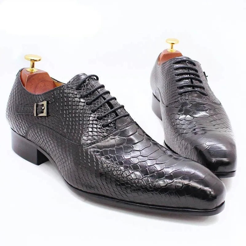 Black crocodile pattern leather men's dress shoes with laces on a white background