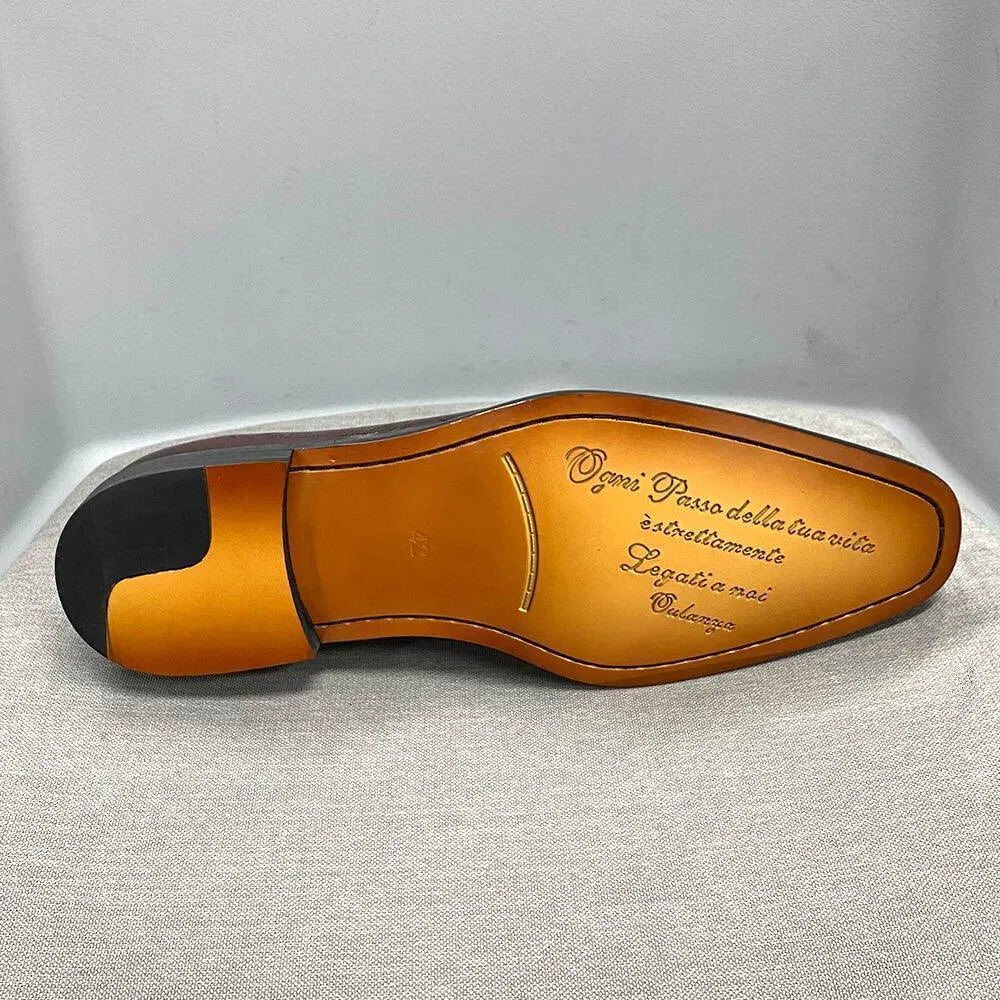Men’s color block dress shoe with leather sole, decorative script engraving, and black heel tip