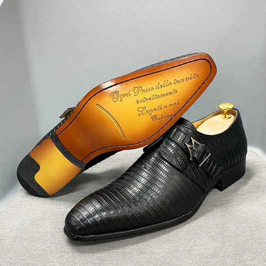 Black textured leather men's dress shoes with buckle on display, one shoe showing engraved sole.