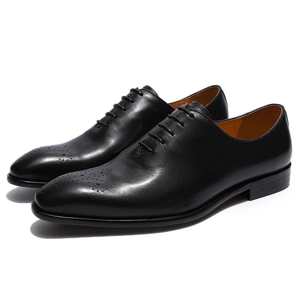 Black leather men's oxford dress shoes with closed lacing on white background