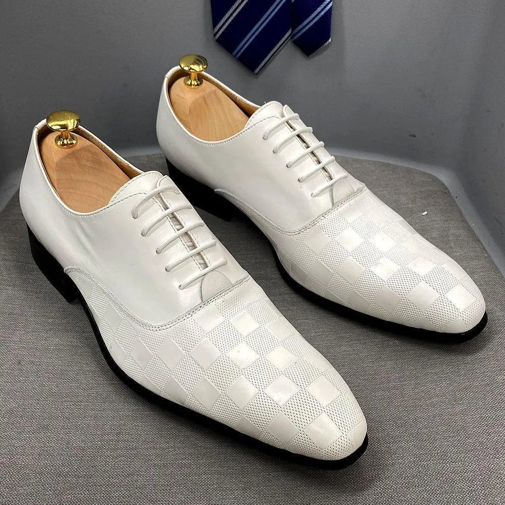 White checkered leather men's dress shoes with laces on gray surface