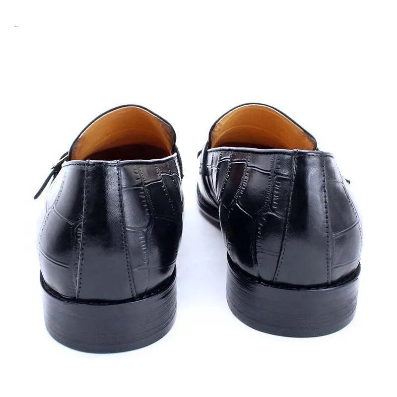 Back view of black leather men's dress shoes with embossed crocodile pattern