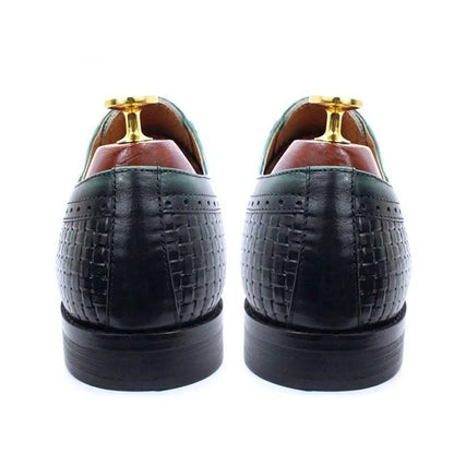 Rear view of black woven leather men's dress shoes with green trim and shoe trees