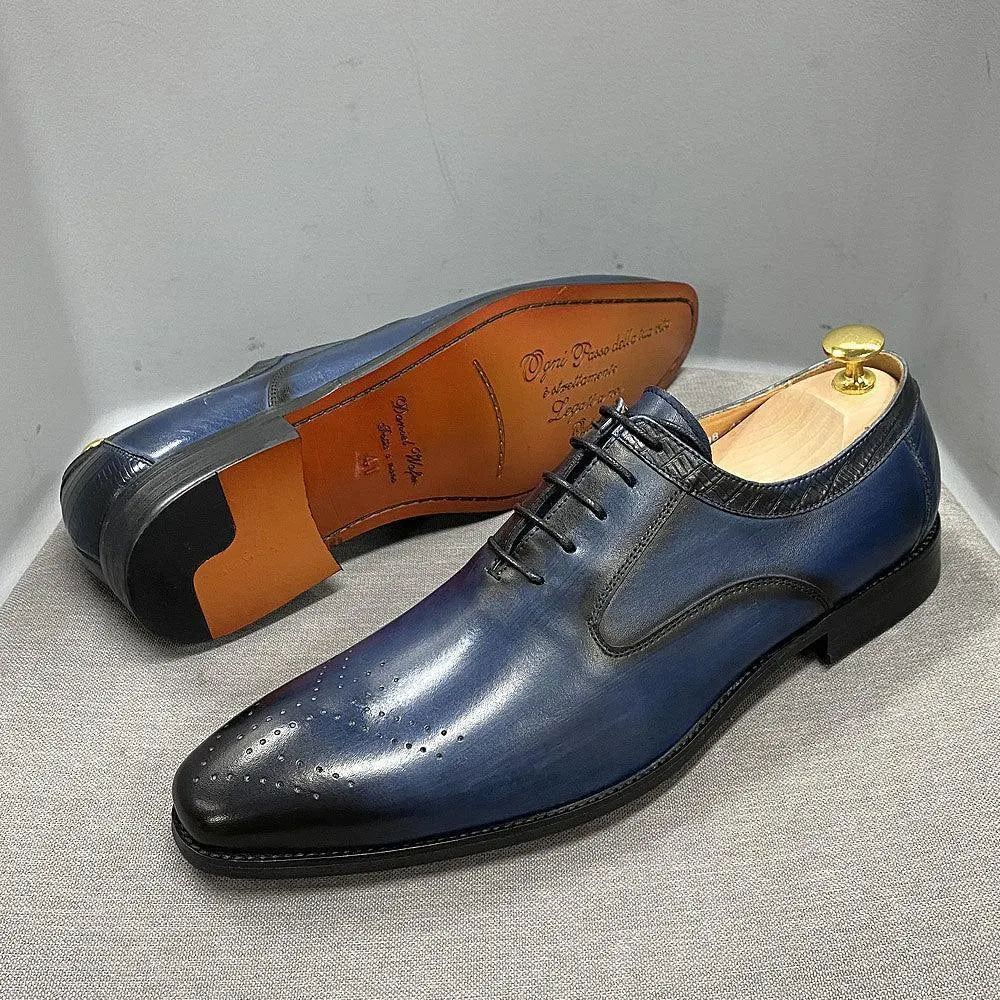 Glossy blue lace-up men's dress shoes with black accents and perforated toe detail