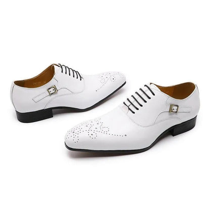 White men's lace-up dress shoes with brogue detailing and silver buckles on a white background