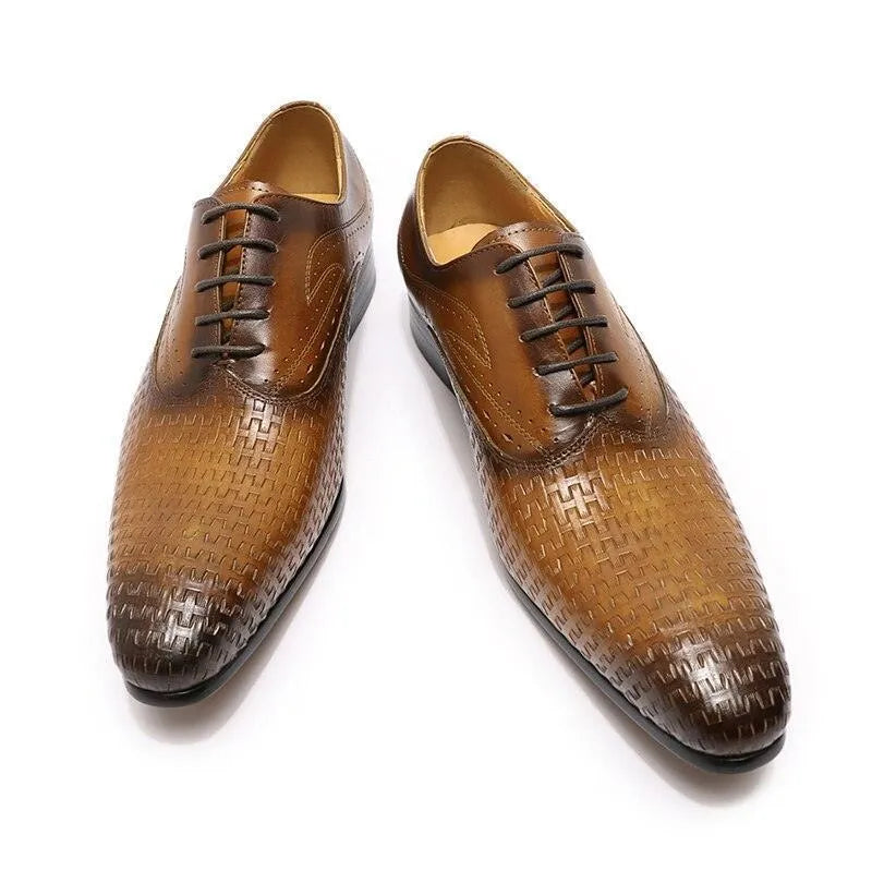 Brown leather dress shoes with pointed toe and textured pattern on white background