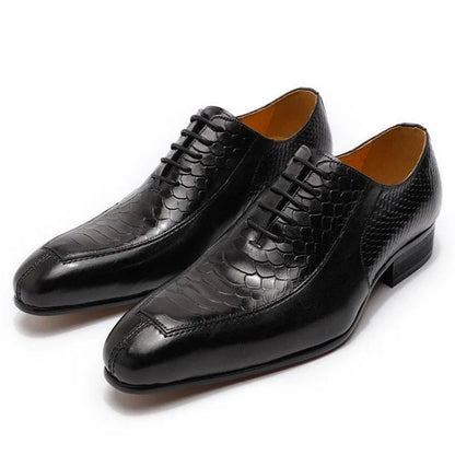 Black leather men's dress shoes with textured snakeskin pattern on a white background