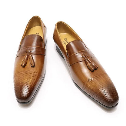 Brown leather men's tassel loafers with woven toe design on white background