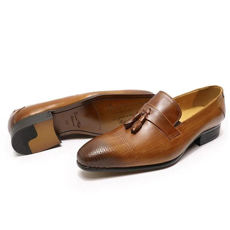 Brown leather men's tassel loafers with textured toe and small heel on white background.