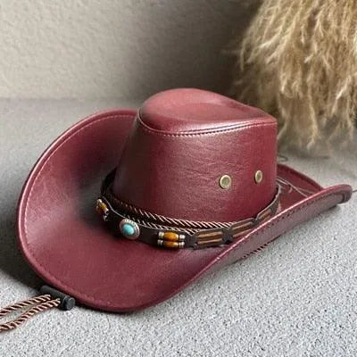 Brown faux leather western cowboy hat with beaded band on a gray surface