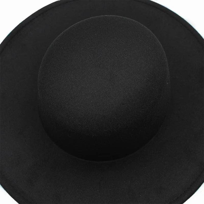 Black flat top fedora hat for women with wide brim, viewed from above