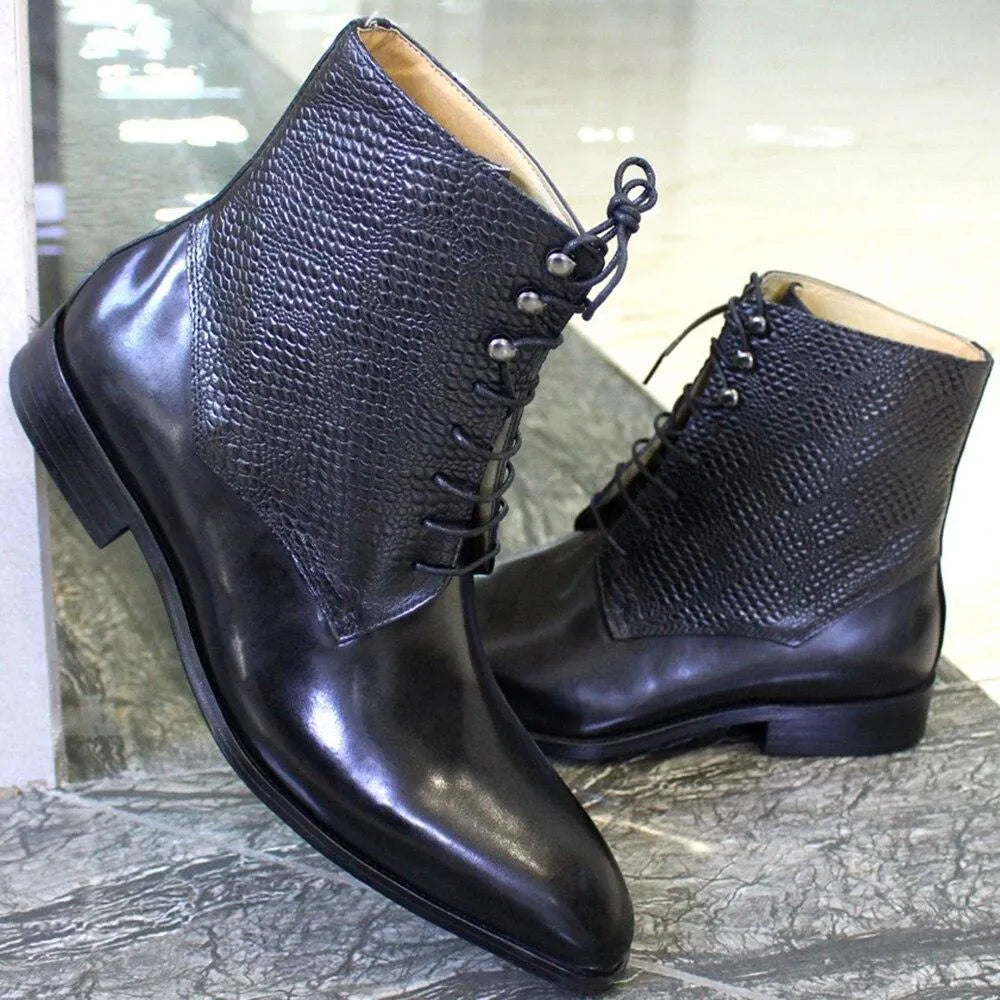 Black leather ankle boots with textured upper, lace-up design on a marble floor
