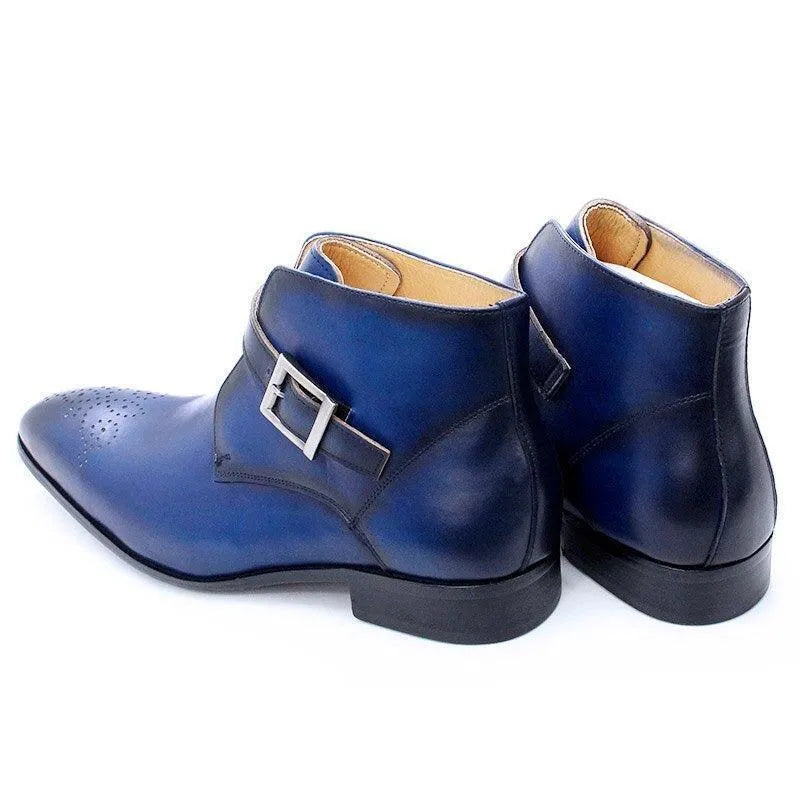 Blue leather men's ankle dress boots with buckle and brogue toe detail on white background