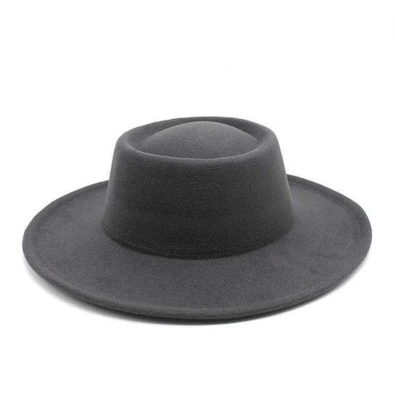 Black fedora hat with wide brim on white background, stylish men's accessory