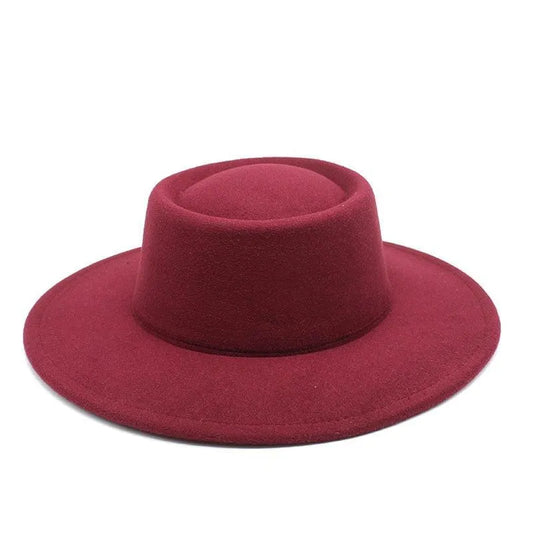 Burgundy fedora hat with wide brim and flat crown on white background