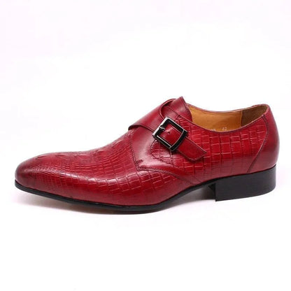 Red leather men's dress shoe with buckle and crocodile texture on white background