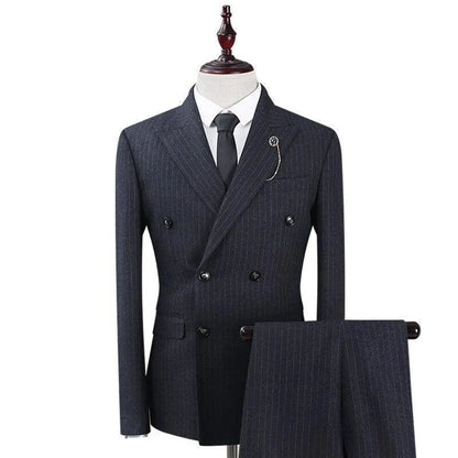 Men's dark striped three-piece suit with double-breasted jacket and tie on mannequin