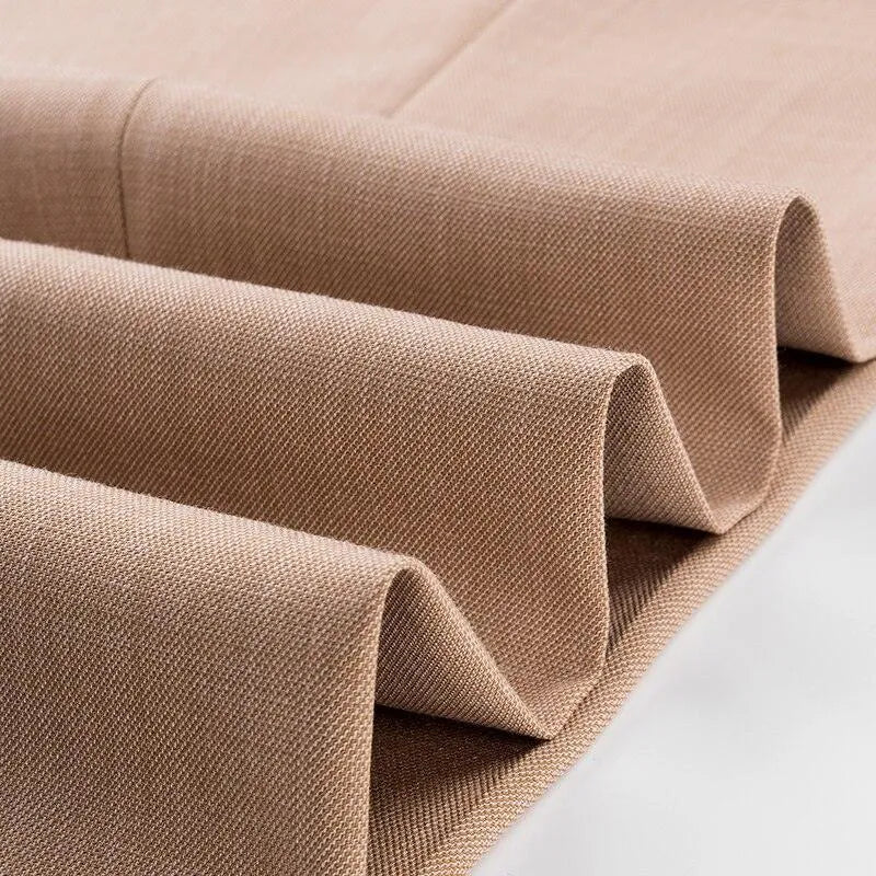 Close-up of folded camel suit fabric with textured weave, ideal for men's 3-piece suit.