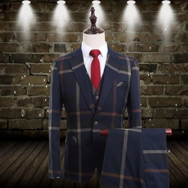 Men's plaid 3-piece suit with red tie on mannequin, brick wall and spotlights backdrop