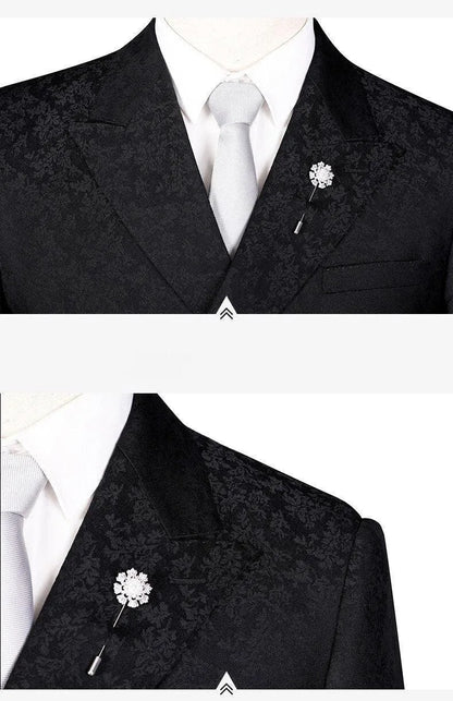 Men's jacquard double-breasted black suit with white shirt, tie, and floral lapel pin