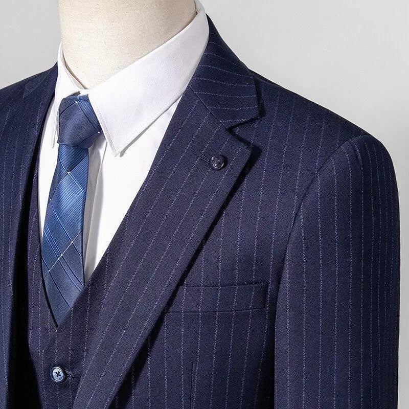 Navy blue pinstripe three-piece suit with blue tie and white dress shirt