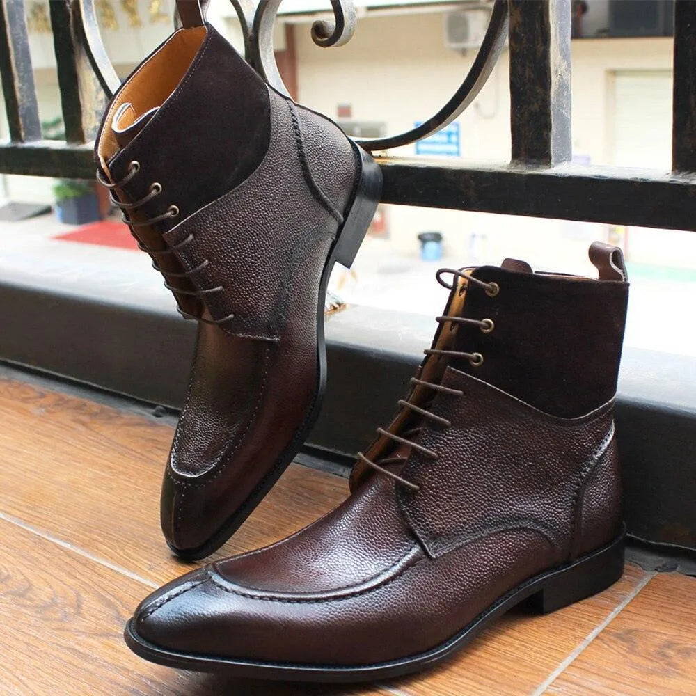 Brown leather lace-up ankle boots with textured finish on wooden floor