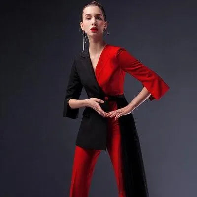 Woman wearing red and black pantsuit with detachable veil on dark background